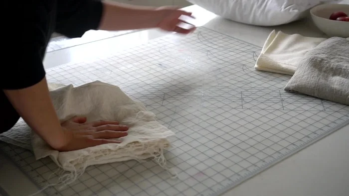 Cut two batting squares the same size as your fabric squares.