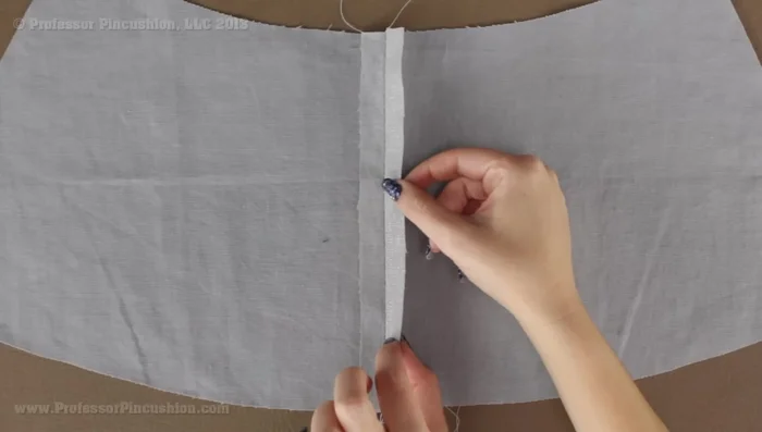 Flip the seam allowances to one side, exposing the wrong side of the fabric. This prepares for zipper placement.