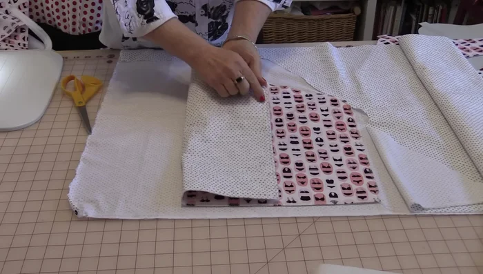 Sew the two front pieces together along the curved edges, creating the pocket opening. Optionally, add decorative lace or binding along the raw edges before sewing.