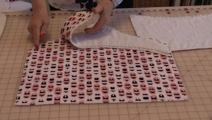 Pin and sew the top of the pocket to the back of the bag, then sew the entire bag together (except for an opening on top). Trim the corners, turn right side out, and press.