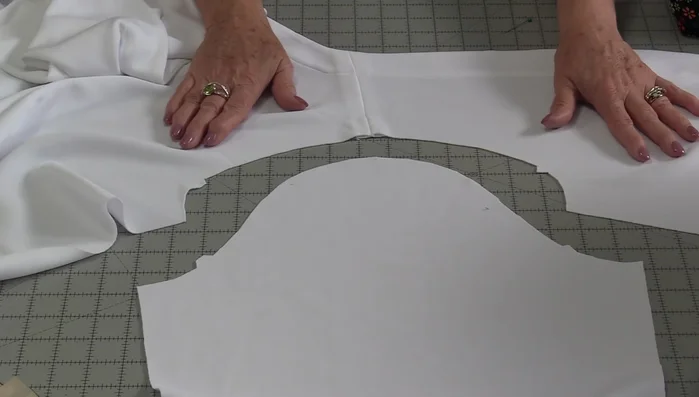 Pin sleeve to garment: Place garment right-side up, align notches and dots, ensuring correct sleeve placement. Pin, leaving tails of basting threads.