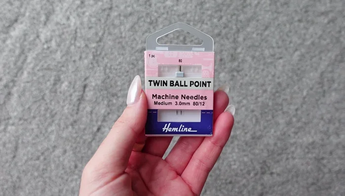 Hem the sleeves and bottom of the dress using a twin needle, zigzag stitch, lettuce hem, or other stretchy finishing method. Sew from the top, folding and pinning the fabric.