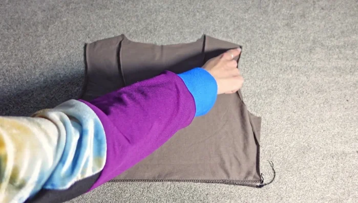 Attach the facing pieces to the dress pieces to finish the neckline. Sew along the entire neckline with right sides together, then pull the facing through.