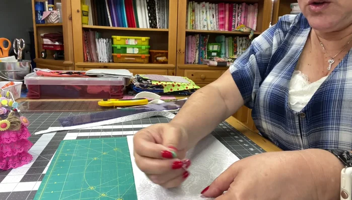 Place the second fabric piece (right side facing the first) on top of the layered pieces, aligning edges. Pin or clip in place. Insert the handle into the top edge of the layered fabrics.