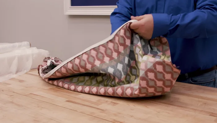 Turn the cushion right-side out. Push the corners out and insert the foam (optionally wrapped in silk film).