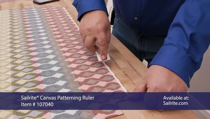 Apply the zipper, basting it in place using the double-sided tape and then sew it to the fabric.