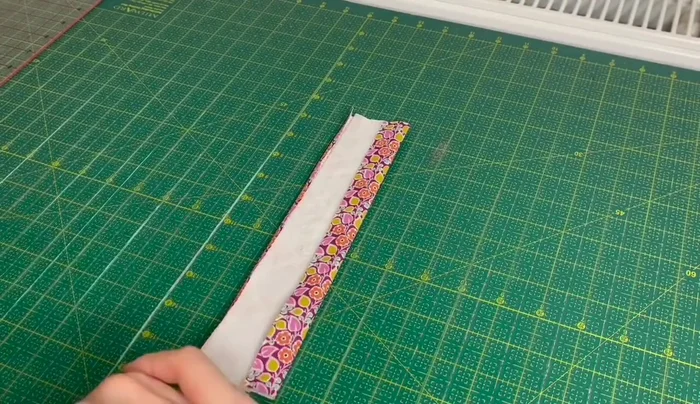 Fold the fabric in half again, matching the ironed edges, and press.