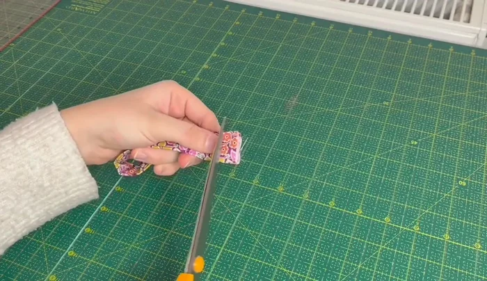 Partially close the metal key fob tab with pliers.