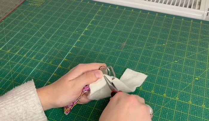 Add a piece of wadding (optional) and fully close the tab using pliers.