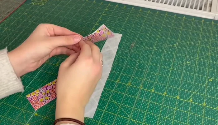 Fold the fabric in half again, matching the ironed edges, and press.