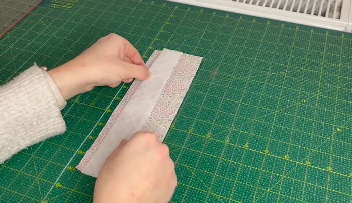 Fold the fabric in half again, matching the ironed edges, and press.