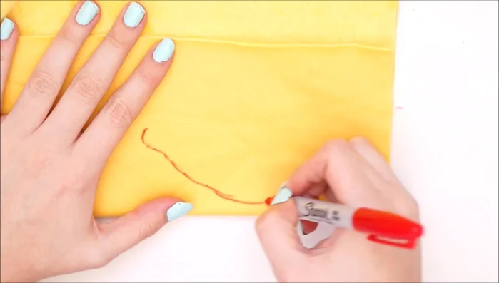 Cut out lemon shapes from yellow plush fabric. Fold fabric in half and draw a chubby lemon shape. Cut out two identical shapes.