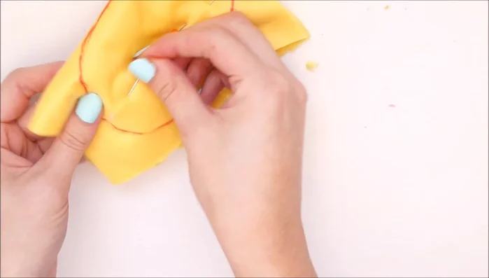 Trim excess fabric and make small snips around the curved edges to facilitate turning. Turn the lemon right-side out.