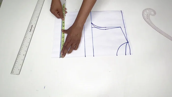 Place half your nipple-to-nipple measurement on the bust line and waistline, then connect these points. Add half an inch on each side and connect to form the bust dart.