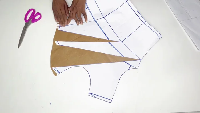 Stitch the front pleats at the shoulder line using your sewing machine (1/2 inch seam allowance). Attach the neckline facing.