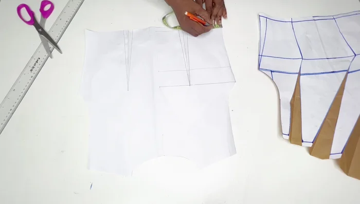 For the back pattern, remove the extra fabric from the side seams since it's a stretchy fabric. Measure 1 inch from the side and cut towards the chest line.