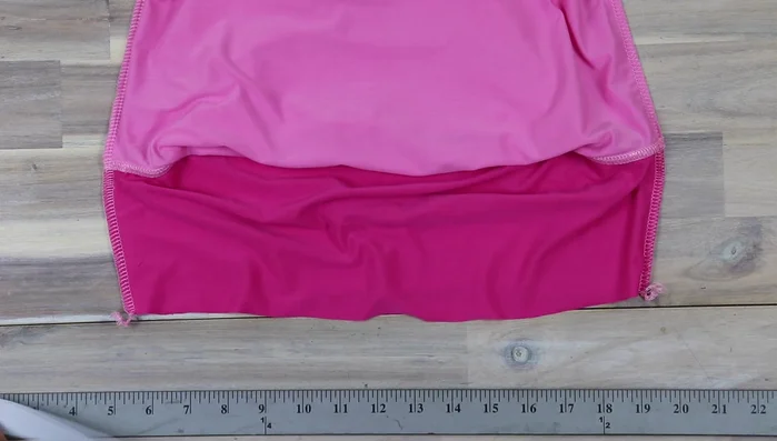 Attach elastic to shelf bra. Cut elastic according to the chart. Overlap ends ¾ inch, sew together. Fold, mark the other side for the center. Line up the marked side of the elastic to the right side of the facing, sew with zigzag stitch, fold and secure inner edge.