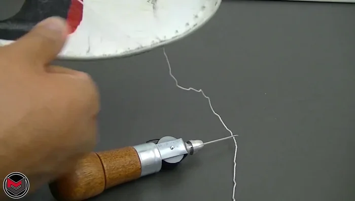 Pull the outer thread to tighten the stitch. Continue this process, stitching around the toe cap.