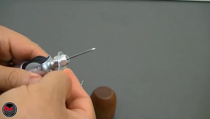 If using a new spool of thread, unscrew the spool cap to replace the thread. Source thread from fabric shops like Michaels or Joann's.