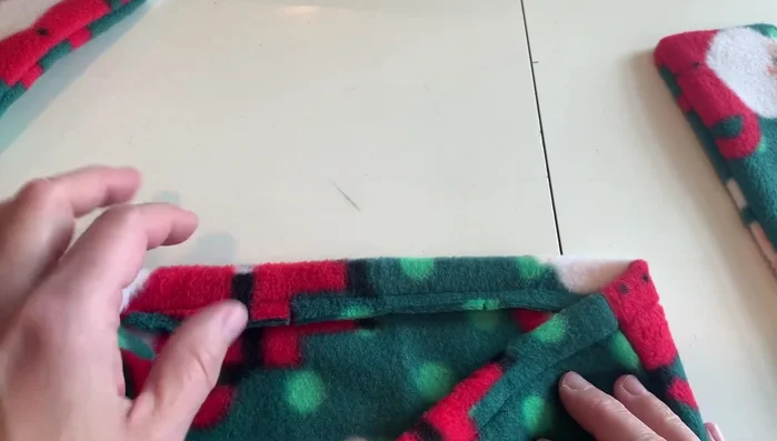 Stitch along the existing stitch line on the exterior of the pillowcase to attach the ties securely.