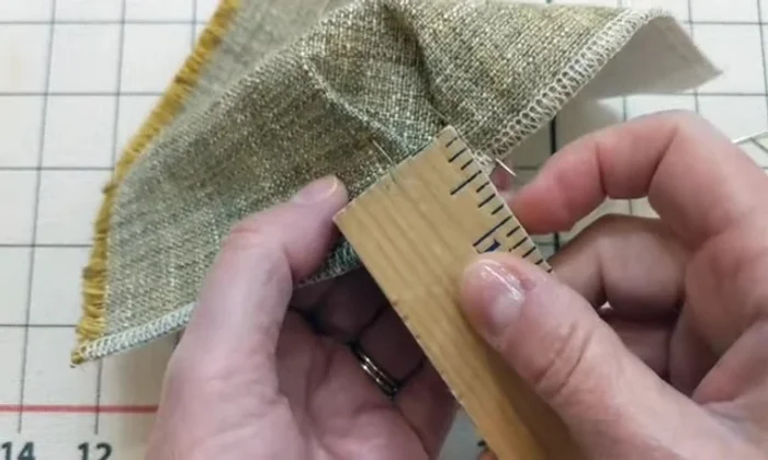 Account for seam allowance (1/2 inch recommended) by overlapping the fabric sections in the center if necessary, to create a sharp point rather than a gap, prior to sewing.