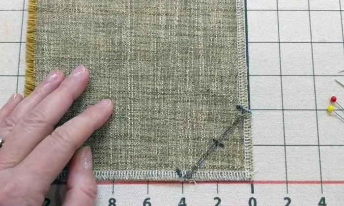 Mark the center point of the line you just drew. Cut along the drawn line.