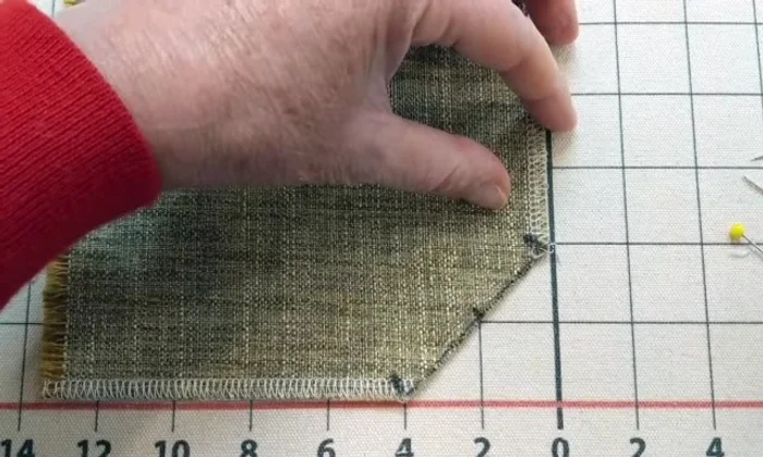 Fold the fabric back to create the pleat.