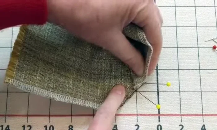 Fold the fabric back to create the pleat.