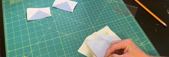 Cut along the pencil line to create two half-square triangles.