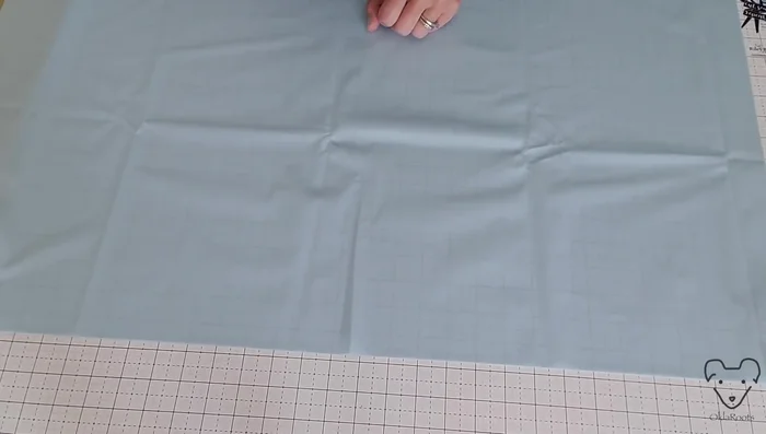 Press the pull fabric lining using low heat and steam. (Note: The narrator had difficulty with this step and suggests experimenting with dry pressing on low heat if steam doesn't work well)