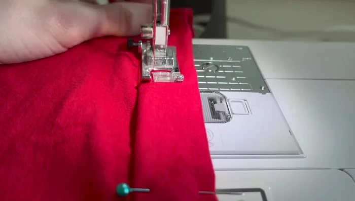 Sew a seam across the pinned edge to eliminate the raw edge.