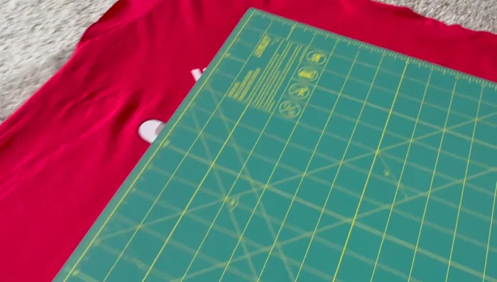 Measure the pillow and t-shirt fabric to determine the size of the pillowcase. Ensure the design fits on the front.