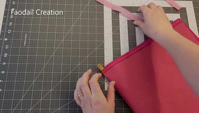 Attach velcro to the center of one of the back sections (using a diagonal stitch for extra security). Repeat for the other back section.