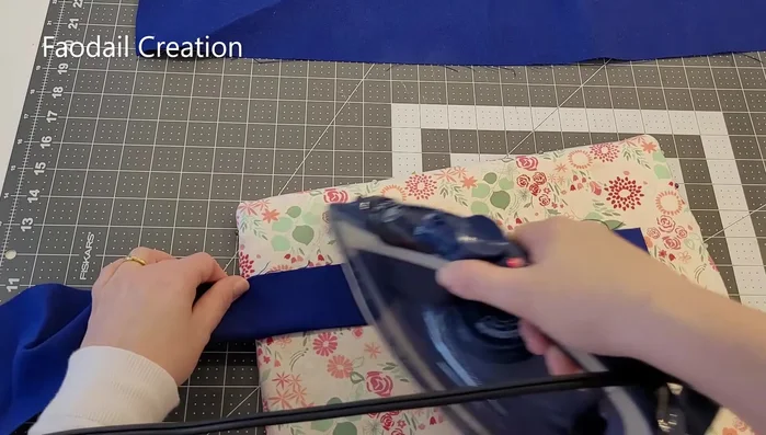 Create the handles. Fold fabric strips in half lengthwise, then fold the sides into the center and press. Fold again to create a double-layered strap. Sew two seams down the length of the strap. Repeat for the second handle.