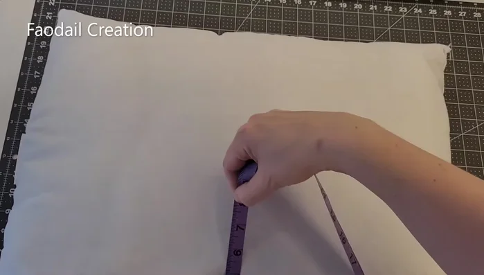 Measure the pillow and cut the fabric. Add an extra inch to your measurements (25 inches by 20 inches in this example).