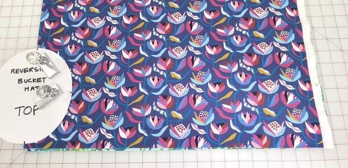 Cut fabric: Place the hat top pattern (oval shape) lengthwise on the fold. Cut out crown and brim pieces from both prints, using notches to mark center and sides.