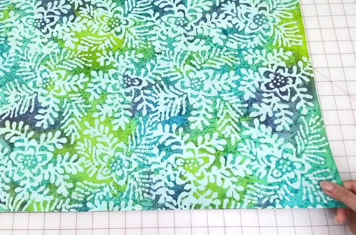 Prepare fabric: Wash, dry, and press two cotton prints. Fold in half and layer them with folds matching.