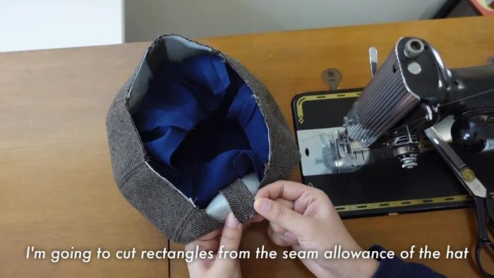 Sew the lining to the hat, starting from the center of the brim and working outwards.