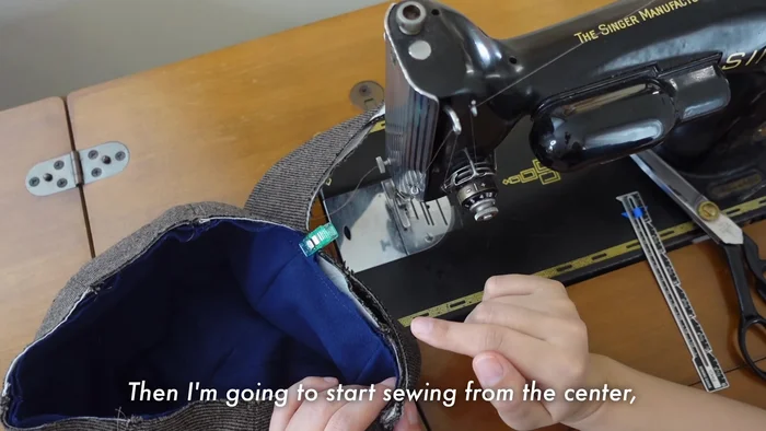 Sew the lining to the hat, starting from the center of the brim and working outwards.