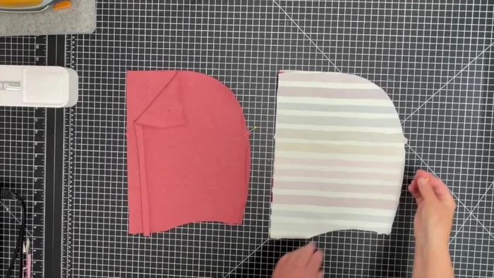 Sew the lined hood: Pin and stitch the main fabric pieces together, then sew the lining pieces together. Pin the main fabric to its lining (right sides together), matching seams, and stitch along the long straight edge.