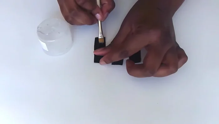 Glue fabric flaps: Glue only the bottom half of each flap, leaving the top open for lacing. Fold each flap in half and glue to the inside of the shoe at each marked dot.