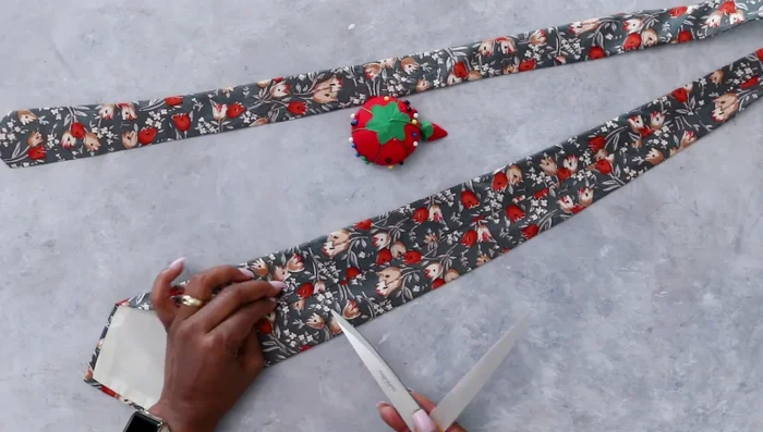 Remove labels and excess tie material to achieve desired snake head width.