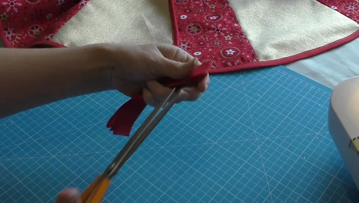 Create fabric tabs from leftover bias binding and sew them to the skirt for fastenings.