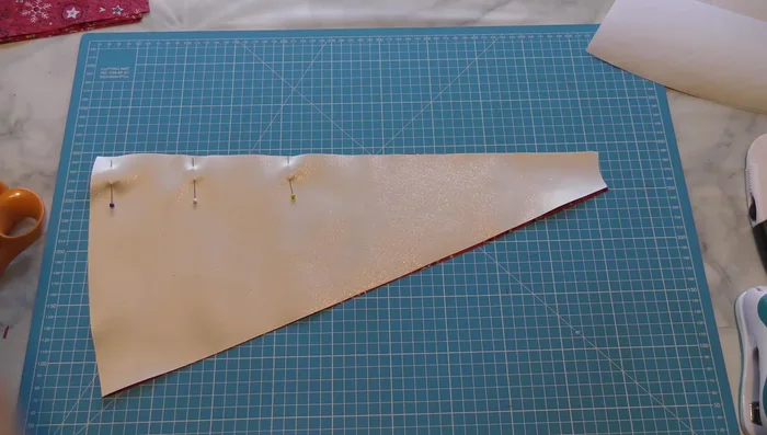 Sew triangular fabric pieces together in pairs, right sides together, alternating fabrics and leaving a 1/4 inch seam allowance.