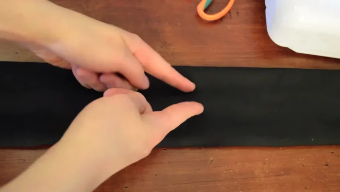 Gather the ruffle using two rows of stitching along the long edge. Pull the top threads to gather evenly, avoiding pulling the bottom threads.