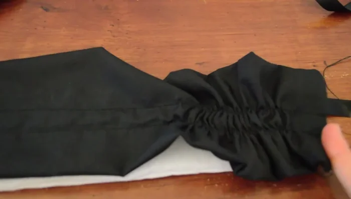 Pin the gathered ruffle to the headband, positioning it off-center. Zigzag stitch the ruffle to the headband.