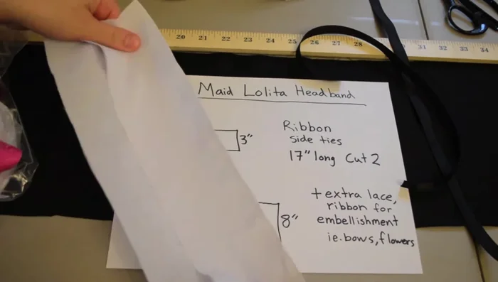Cut fabric pieces: Two 12 1/2 x 3 inch pieces for the headband base, one 36 x 8 inch piece for the large ruffle, and two 17 inch pieces for the side ties.