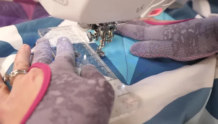 Repeat this for all chosen triangles, using a less dense stitch density in the mini-pinwheel to enhance its visual impact.