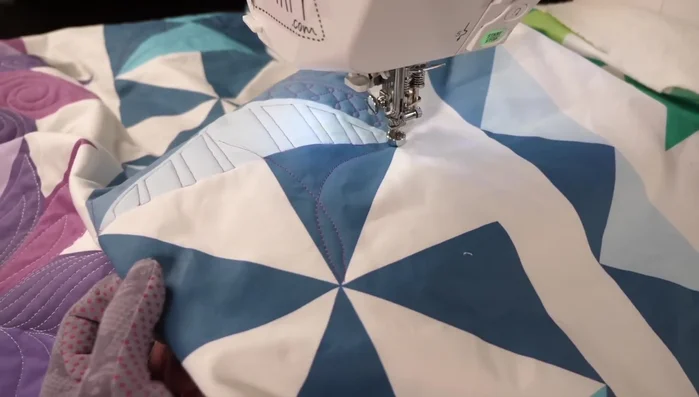 Use stitching in the ditch to smoothly transition between sections and connect your curves.