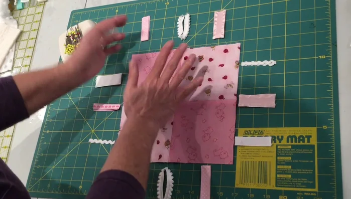 Pin ribbons to the edges of the fabric top, leaving approximately ¼ inch of overhang.